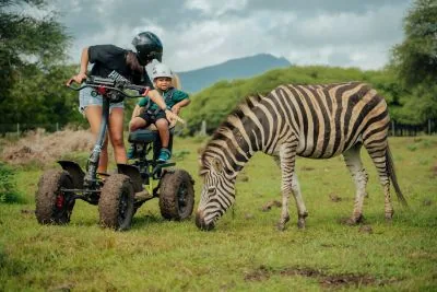 Safari Eco Rider visitors beside a zebra at Casela Nature Parks in Mauritius.